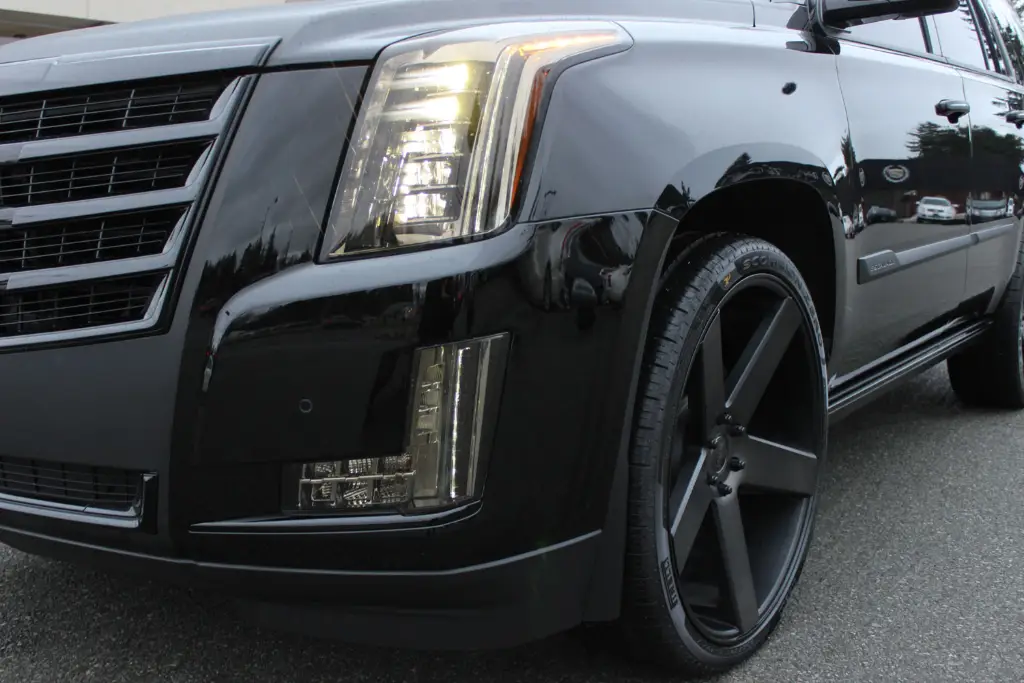 Black Cadillac Escalade with matte black custom wheels